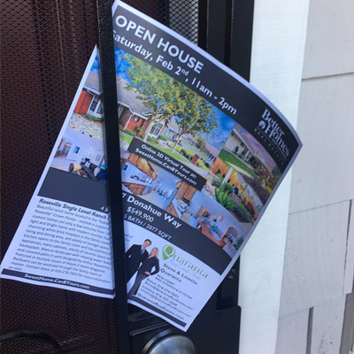 open_house_flyer_on_the_front_door_of_a_home
